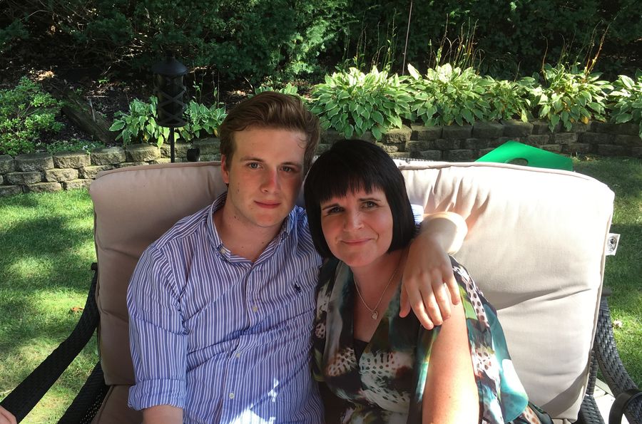 John and his mum sitting together in the garden